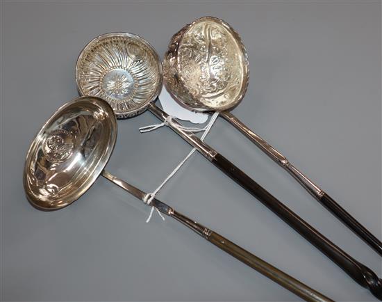 A Georgian coin-set punch ladle with plain oval bowl and whalebone handle and two other punch ladles